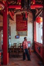 Songkhla, TAHILAND - Local guy at old vintage building of Songkhla city pillar shrine with Chinese lanterns at Nang