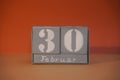 30 Februar on wooden grey cubes. Funny calendar date 30 February. Concept of date. Copy space for text