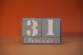 31 Februar on wooden grey cubes. Funny calendar date 31 February. Concept of date. Copy space for text