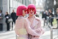 Asian models with pink bob hair wear a pair of semitransparent red glasses during the Armani fashion show at the women`s fashion w