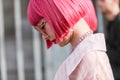 Asian models with pink bob hair wear a pair of semitransparent red glasses during the Armani fashion show at the women`s fashion w