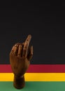 February Black History Month. Brown wooden hand on Paper geometric black, red, yellow, green background. Copy space