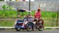 February 16, 2021, Bojonegoro, Indonesia. a motorized rickshaw driver who is waiting for passengers on the side of the road.