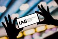 February 6, 2023, Brazil. The International Airlines Group (IAG) logo is displayed on a smartphone