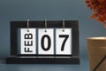 February 07, Date design with a black wooden calendar for a business.