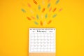 February 2024 desk calendar and colorful metal paperclips Royalty Free Stock Photo