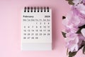 February 2024 desk calendar on pink background Royalty Free Stock Photo