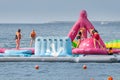 Adults and children with families have fun and run around the AquaFun water park in Dubai