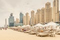 Empty deckchairs with umbrellas and sun beds at the JBR beach in Dubai. Travel and vacation Royalty Free Stock Photo