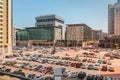 Large filled open-air parking lot with hundreads of cars near the hotel and business center in Dubai