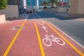 White painted bike path on the sidewalk near the highway. Concept of safe bicycle infrastructure and