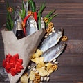 February 23. Gift for men. A bouquet of dry fish, chips, pistachios, green onions, chili peppers. Decorated with a red bow. Men`s Royalty Free Stock Photo