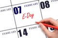 February 7. Hand writing text e-Day on calendar date. Save the date.