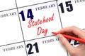 February 14. Hand writing text Statehood Day on calendar date. Save the date.