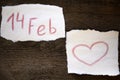 February 14 and the heart is drawn in red pencil on a sheet of paper, everything is located on a wooden board Royalty Free Stock Photo