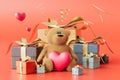 february 14 holiday. teddy bear with a heart next to the gift boxes on a red background. 3D render Royalty Free Stock Photo