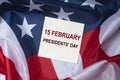 15 february inscription on paper with american flag background. President day in USA Royalty Free Stock Photo