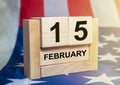 15 february inscription on wooden calendar with american flag background. President day in USA Royalty Free Stock Photo