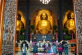 Three Buddha and people praying at Main shrine of Sangha Fo Guang Shan Monastery in Kaohsiung Taiwan