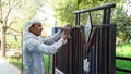 Portrait shot of Indian painter making paint art on Enter gate. Renovation of gate with oil paint