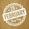 29 February Leap Day rubber stamp white on a crumpled paper brown background.