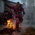 Mascaraed People jumping cross bonfires in an ancient tradition of Carnival in Vila Boa de OusilhÃ£o. Royalty Free Stock Photo