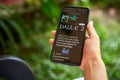 February 5, 2023, Mirissa, Sri Lanka. Using OpenAI DALL-E on phone. Woman testing artificial intelligence image
