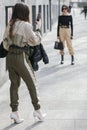 Model wears a black handbag, a black long-sleeved shirt and a pair of beige pants during the Armani fashion show at the women`s fa