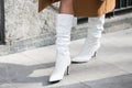 Model wears a brown overcoat and a pair of white boots during the Armani fashion show at the women`s fashion week fall / winter 20