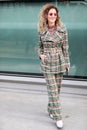 Model wears green and brown checked trousers and jacket during the Armani fashion show at the women`s fashion week fall / winter 2