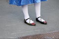 Model wears a shiny blue skirt, white stockings and black flat shoes during the Gucci fashion show at the women`s fashion week fal
