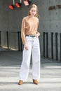 Model wears white jeans and a brown long-sleeved shirt during the Armani fashion show at women`s fashion week fall / winter 2020 i