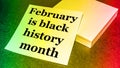 February is the month of black history  written on a stack of paper  tinted gradient background green  yellow  red Royalty Free Stock Photo