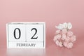 February 02nd. Day 2 of month. Calendar cube on modern pink background, concept of bussines and an importent event