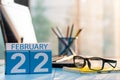 February 22nd. Day 22 of month, calendar on financial adviser workplace background. Winter concept. Empty space for text