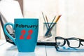 February 22nd. Day 22 of month, calendar on financial adviser workplace background. Winter concept. Empty space for text