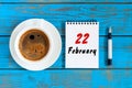 February 22nd. Day 22 of month, Top view on calendar and morning coffee cup at workplace background. Winter time