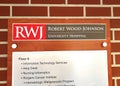Robert Wood Johnson University Hospital placard on interior faux red brick pattern wall Royalty Free Stock Photo