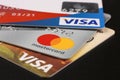 Three bank credit cards with Visa and Mastercard logos on a black background Royalty Free Stock Photo