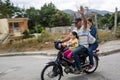 February 22, 2020 Ocoa, Dominican republic. image of three people on one motorcycle with no helmets.