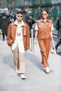 Pair of models wearing a brown overcoat and leather pants during the Armani fashion show at the women`s fashion week fall / winter