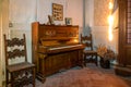 Piano illuminated by morning light in an abandoned house, Urbex In northern Italy