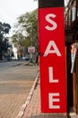 February 21st 2021 Dehradun India. A SALE sign board outside a commercial store with red background