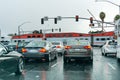 February 2, 2019 Sunnyvale / CA / USA - Vehicles waiting at a red traffic light; high speed train passing in the background, San