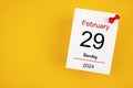 February 29th calendar for February 29 and wooden push pin on yellow background