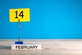 February 14th. Day 14 of february month, calendar on little tag at blue background. Valentines day. Empty space for text