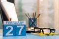 February 27th. Day 27 of month, calendar on author workplace background. Winter at work concept. Empty space for text