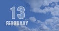 february 13. 13-th day of the month, calendar date.White numbers against a blue sky with clouds. Copy space, winter Royalty Free Stock Photo