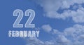 february 22. 22-th day of the month, calendar date.White numbers against a blue sky with clouds. Copy space, winter Royalty Free Stock Photo