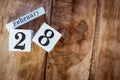 February 28th. Day 28 of February month, white calendar blocks on vintage wooden table background. Winter time. Empty space for